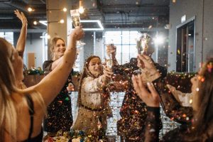A group raises a glass in celebration at Bayview Yards in a cloud of sparkling confetti. 