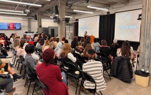 A group of people assembled and seated at an in-person event.