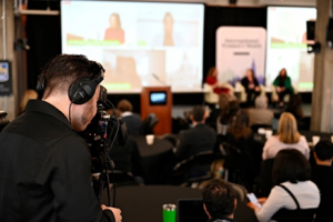 The view from behind a person operating a camera at a live event. 