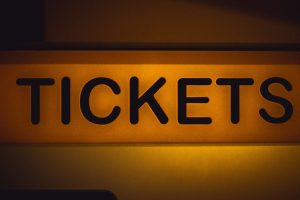 A lit up sign reading "tickets." 