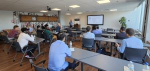 A group is seated listening to a presentation. 