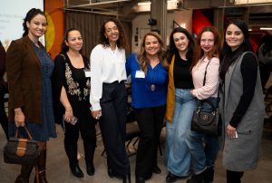 Members of the Immigrant Entrepreneurs Canada group stand and smile for a photo. 