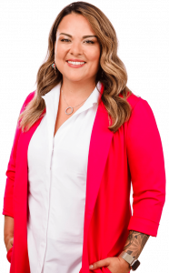 An image of Karla Briones, standing with her hands at her side, smiling. 